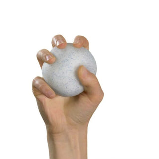 Hand squeezing a white speckled gel stress ball resembling a snowball