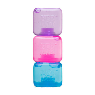 Three stacked Nee Doh Nice Berg stress balls in purple, pink, and blue translucent colors