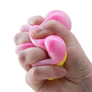 Hand squeezing a pink and yellow Nice Cream Cone Needoh stress ball toy, showing its stretchy texture.
