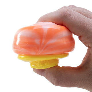 Hand squeezing an orange and yellow Nice Cream Cone NeeDoh stress ball toy by Schylling