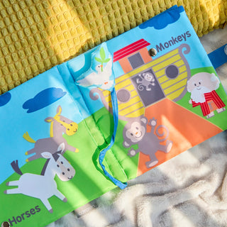 Demdaco Noah and Friends soft fabric sound book open showing Noah's Ark with horses and monkeys