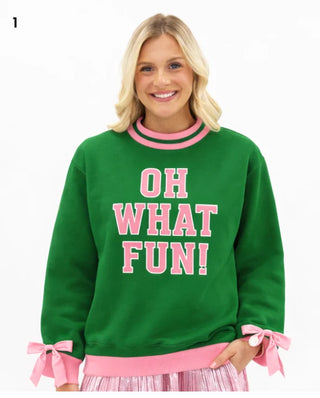 Green mock neck sweatshirt with pink OH WHAT FUN graphic and bow cuffs