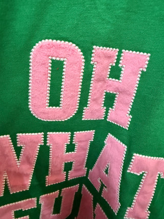 Green sweatshirt with pink chenille letter appliqué reading Oh What Fun