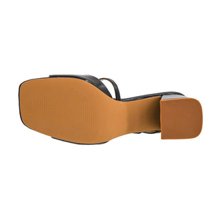 Black patent leather mule sole with ribbed tan insole and textured grid rubber heel grip