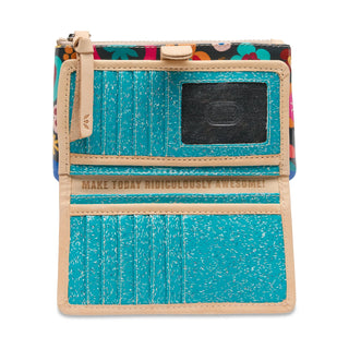 Small wallet with turquoise front panel and floral patterned back, featuring a motivational quote.