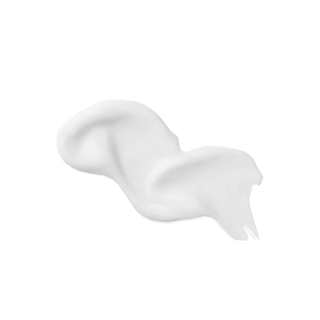 Close-up of thick creamy white Orange Blossom Honey Lotion texture showing smooth non-greasy finish