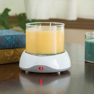 Candle Warmers electric candle warmer with red indicator light melting yellow candle on wooden table