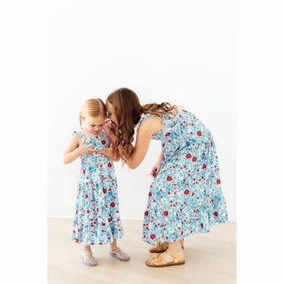Woman and child wearing matching floral dresses 