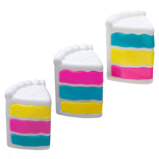 Three cake slice-shaped Needoh stress toys with colorful layered pink, teal, and yellow bands