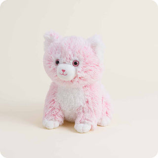 Pink fluffy kitten Warmies stuffed animal with sparkly pink eyes on neutral background