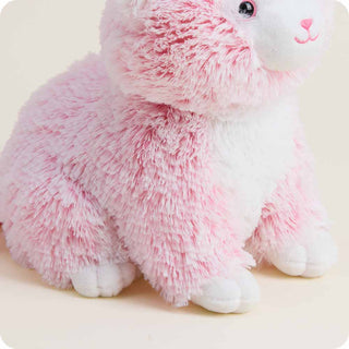 Close-up detail of pink and white fluffy kitten Warmies stuffed animal plush toy