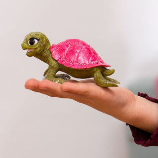 Schleich Pink Sapphire Turtle figurine with bright pink shell held in a child's palm