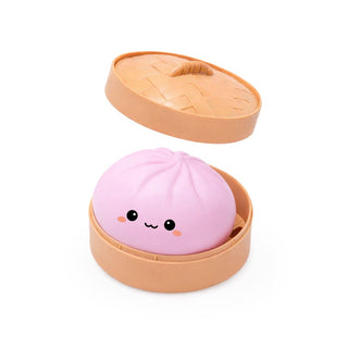 Pink bun-shaped product with a face in an open beige container