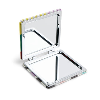 Open compact pocket mirror with colorful checkered edge design showing dual reflective surfaces