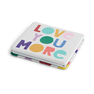 Compact pocket mirror with colorful 'Love You More' text on white background