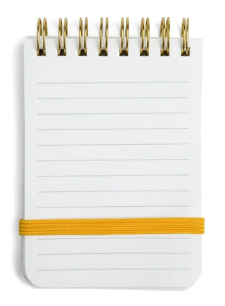 Small white lined spiral notebook with gold rings and yellow elastic band closure.