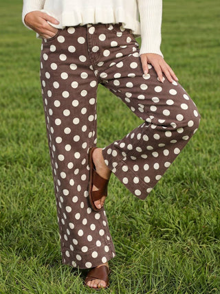 Vine & Love brown wide-leg denim pants with large cream polka dot print