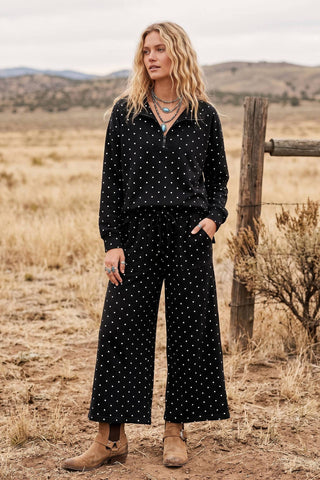 Black white polka dot half-zip pullover and wide-leg pants set with tan boots