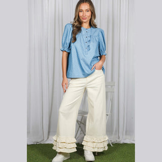 Close-up texture of 100% cotton light blue chambray with small white dots