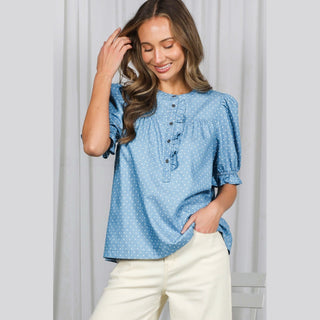 Light blue cotton chambray shirt with dark brown buttons and relaxed fit