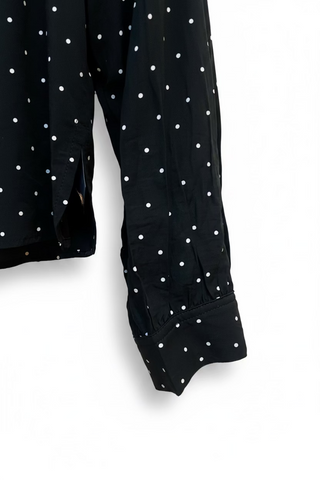 Black polka dot blouse sleeve detail with gathered cuff and white dot pattern