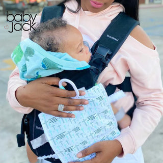 Baby in carrier holding light blue cross scripture crinkle toy