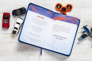 Prayers & Promises for Boys devotional open to Justice page with toy cars and fidget spinner