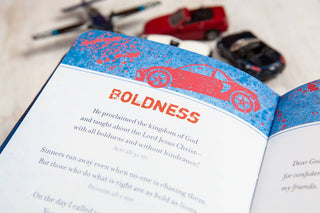 Open Prayers & Promises for Boys book showing Boldness page with toy cars nearby