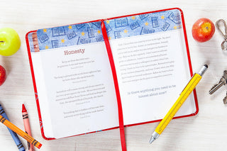 Open red journal showing Honesty prayer pages with apples, crayons, and pen nearby