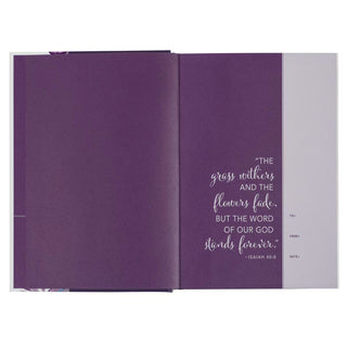 Open purple floral hardcover NLT Bible showing Isaiah 40:8 scripture with To From Date gift fields