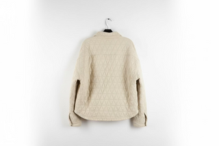 Beige quilted knit shacket with triangle pattern, shown from the back on hanger