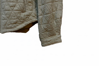 Beige quilted shacket sleeve and hem detail with diamond stitching pattern