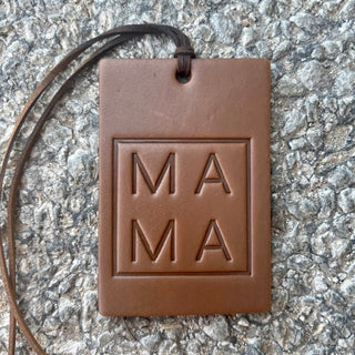 Rectangle brown leather air freshener tag embossed with MAMA text on leather cord