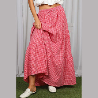 Close-up of red gingham maxi skirt fabric texture, tiered ruffles, and elastic waist drawstring