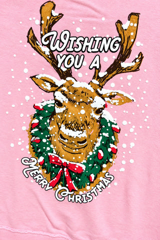 Pink sweatshirt with reindeer and Christmas wreath graphic reading Wishing You a Merry Christmas