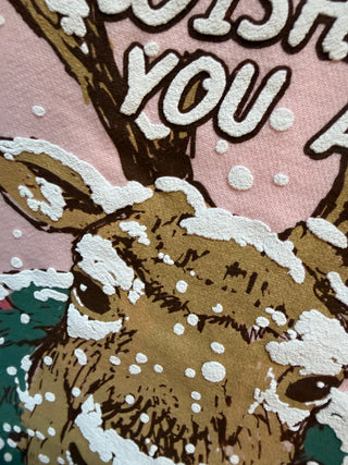 Pink sweatshirt with snow-covered reindeer and Merry Christmas graphic print