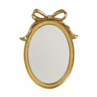 Oval gold resin wall mirror with decorative bow accent on top, vintage style