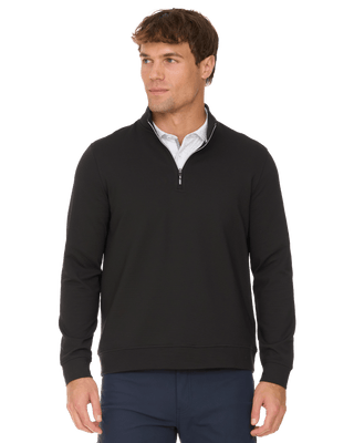 Man wearing black quarter-zip mock neck ottoman stretch pullover with navy pants