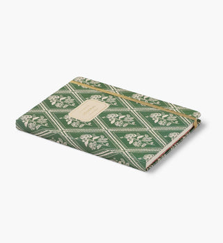 Rifle Paper Co. Rose Study Journal lying flat, green floral diamond pattern cover with gold elastic closure