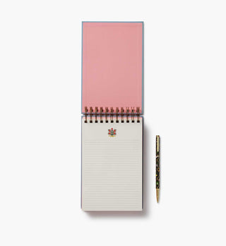 Open Rifle Paper Co. Rosette spiral notepad with pink cover and decorative floral pen beside it