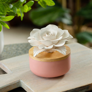 Candle Warmers porcelain rosette aroma diffuser in pink with wooden lid and white flower topper