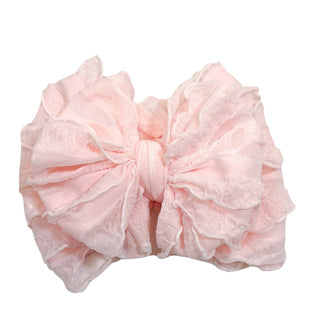 Pastel peach pink ruffled baby headband with double layered white scalloped trim
