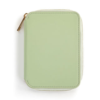 Sage green zip-around passport wallet with gold zipper hardware on white background