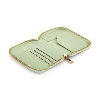 Open sage green zip-around passport wallet showing card slots and interior compartments with gold zipper