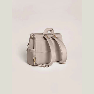 Back view of taupe JuJuBe convertible satchel with padded backpack straps and gold-tone clips