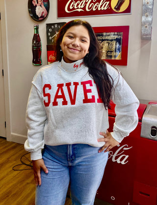 Heather gray mock neck sweatshirt with red SAVED block letter graphic on front