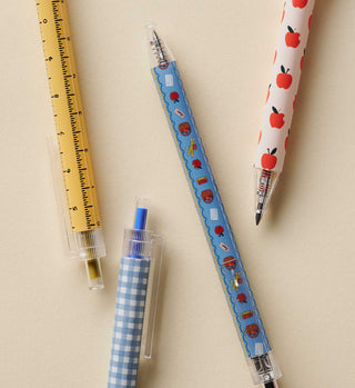 Set of four Rifle Paper Co. Schoolhouse gel pens with ruler, gingham, apple, and schoolhouse patterns.