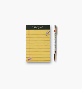 Rifle Paper Co. Schoolhouse Pen beside a yellow lined notepad on white background