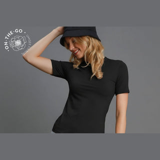 Woman wearing a black t-shirt and black bucket hat