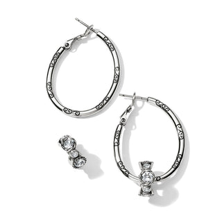 Silver oval hoops with black scrollwork styled with crystal bow charm and stud set